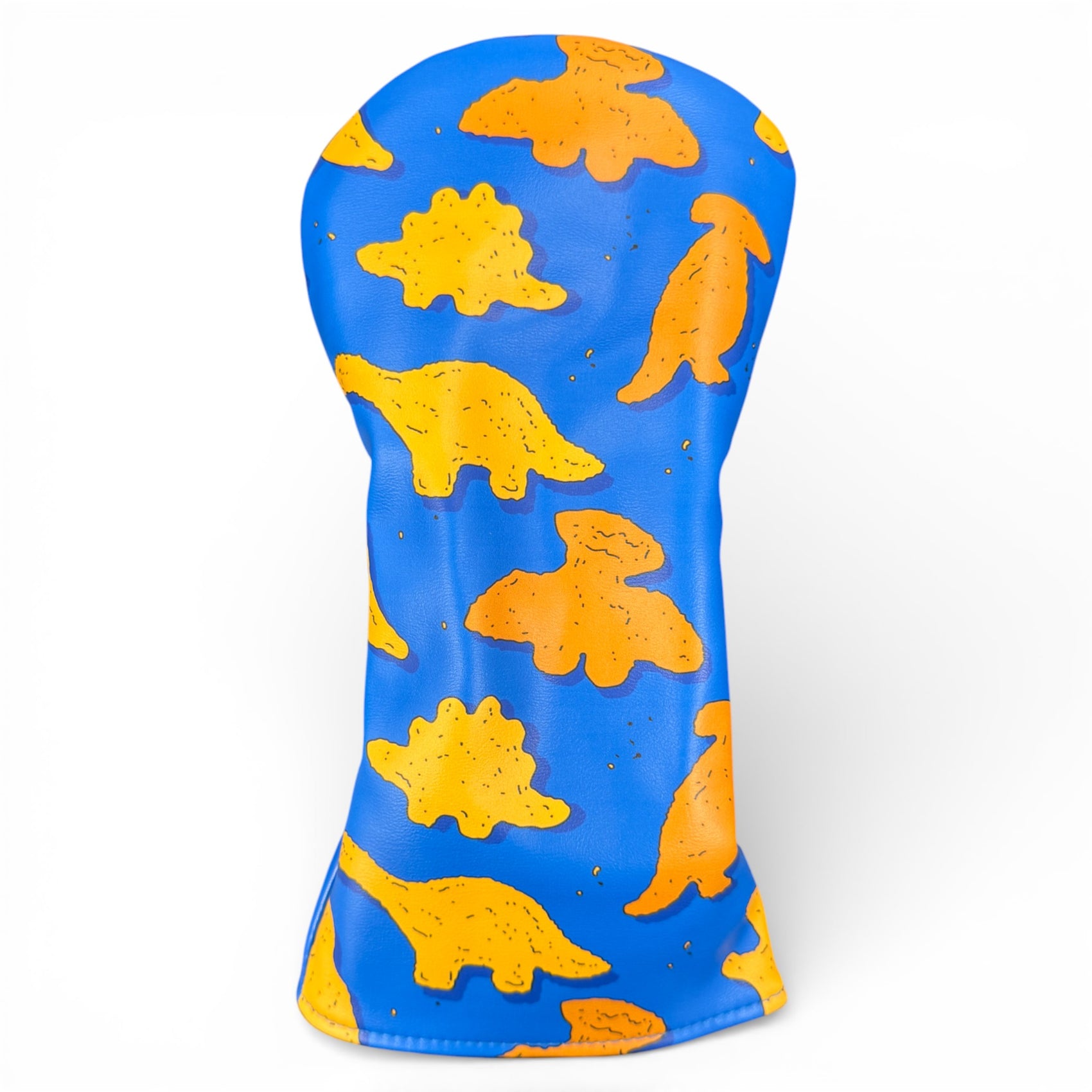 The Dino Nugget Driver Headcover features blue synthetic leather with yellow and orange dinosaur shapes like stegosaurus and pterodactyl, plus soft lining for protection—perfect for golfers seeking playful style.