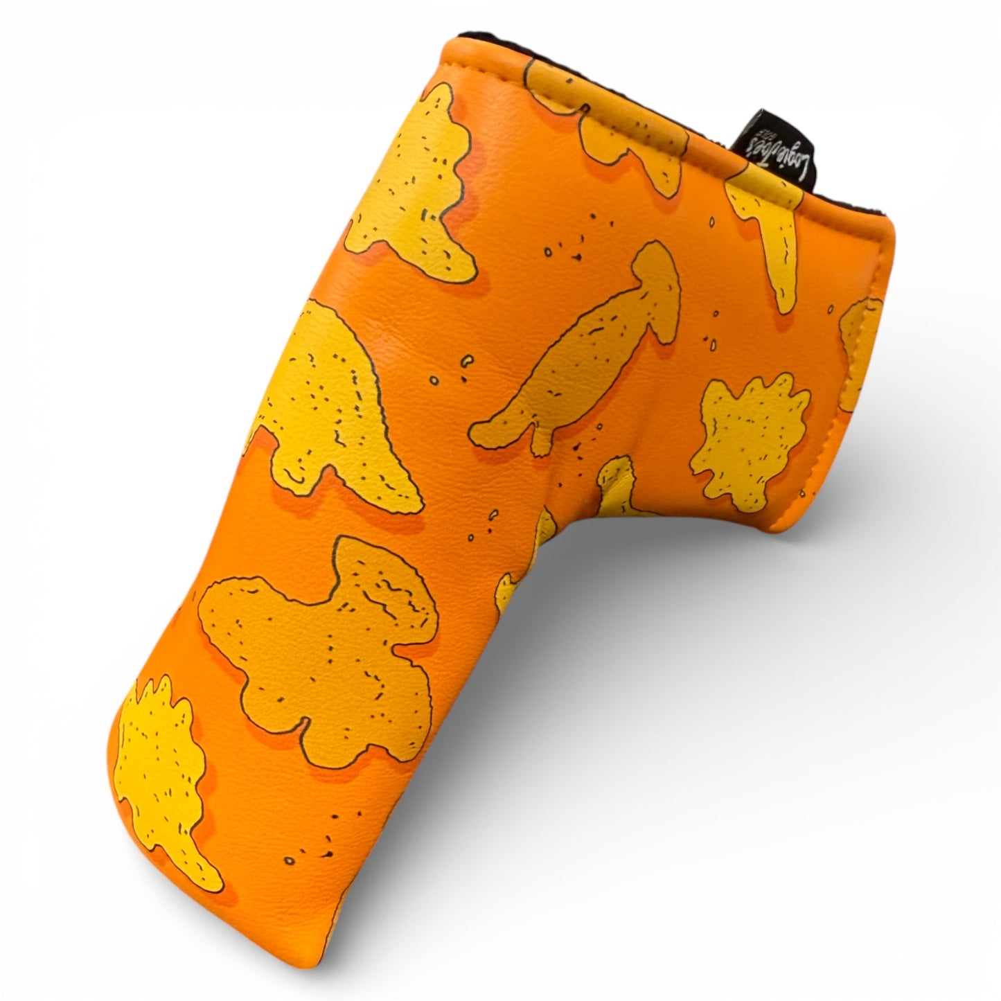 The Dino Nugget Blade Putter Headcover features playful yellow chicken and dino nuggets on orange synthetic leather, plus a small black side tag. Magnetic closure and soft interior protect your putter.