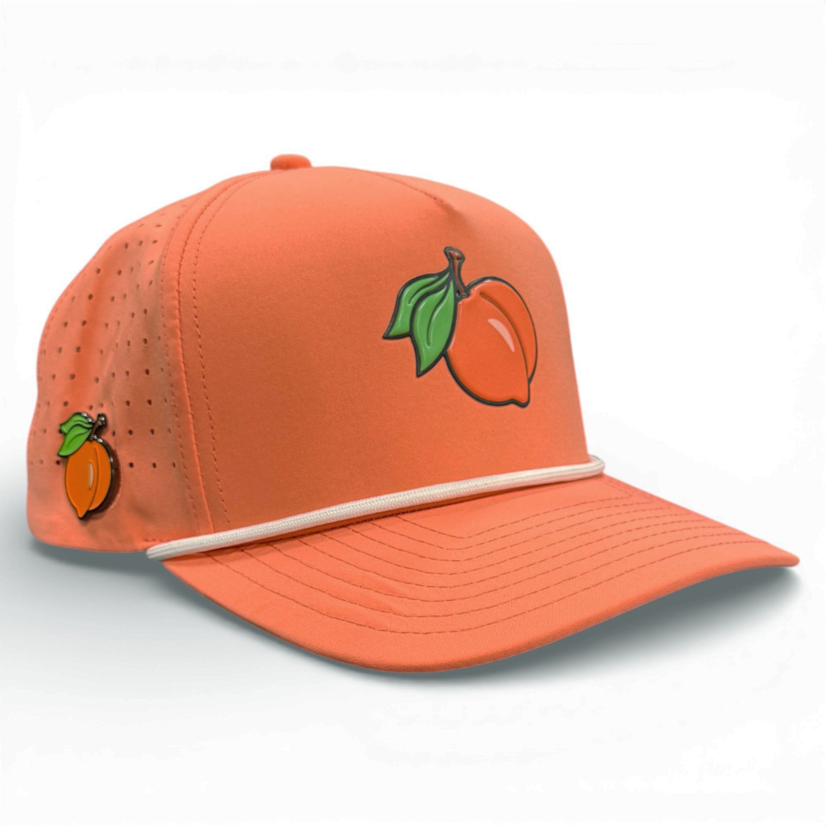 The Just Peachy Golf Hat is an adjustable orange snapback cap with a peach graphic, featuring built-in magnetic ball marker holder plus marker. It has ventilation holes, white trim on the crown's base, and is perfect for sunny golfing days.