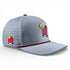The Transfusion Golf Hat is a light gray adjustable snapback cap with maroon trim, perforated side panels, two embroidered cocktail images, and a built-in magnetic ball marker holder with marker—ideal for stylish golf performance.