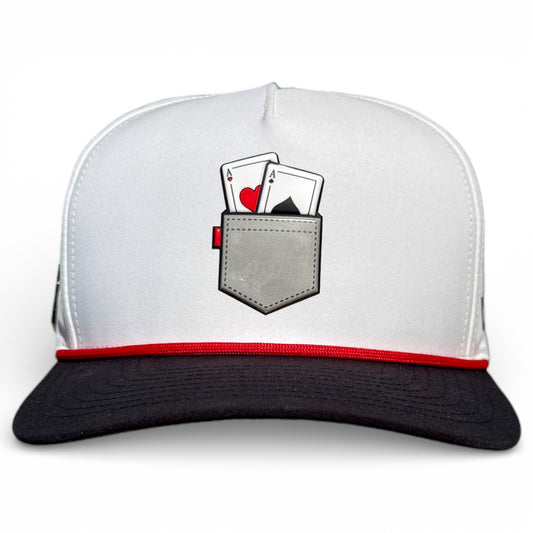 The Pocket Aces Golf Hat is a gray and black adjustable snapback cap with a built-in magnetic ball marker holder (marker included) and features an illustration of a pocket holding an ace of hearts and ace of spades on the front.