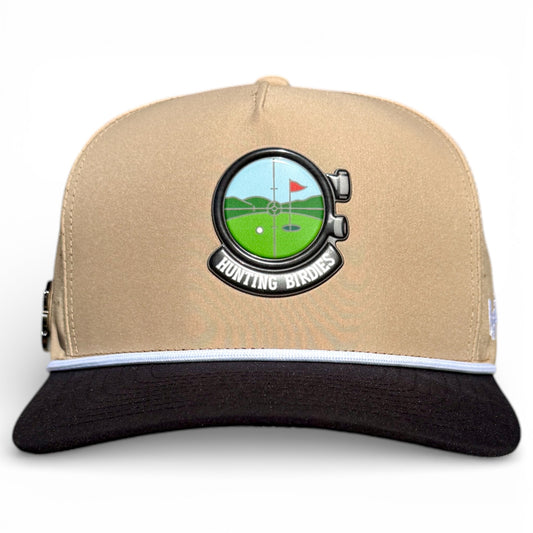 The Hunting Birdies Golf Hat is an adjustable tan & black snapback cap featuring a binoculars golf course patch with a red flag, “HUNTING BIRDIES” text, and a built-in magnetic ball marker holder with marker included for convenience.