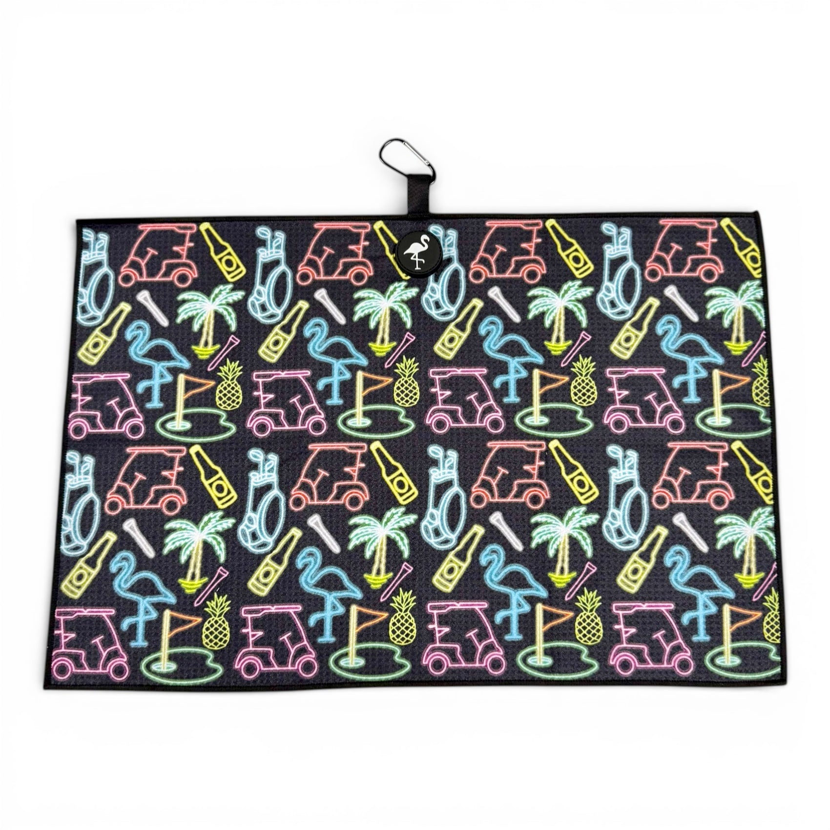 The Miami Slice Golf Towel is a 24 x 16 in premium double-sided microfiber towel, featuring a vibrant neon golf design on a black background. It includes a heavy-duty magnetic attachment and carabiner clip for easy hanging.