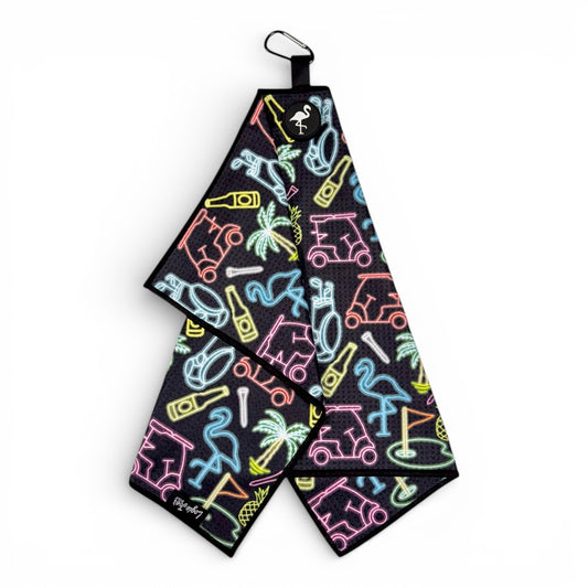 The Miami Slice Golf Towel is a 24 x 16 in premium double-sided microfiber towel in black, with neon-style palm tree, scooter, snorkel, pineapple, and flamingo illustrations. It features a heavy-duty magnetic carabiner clip for easy hanging.