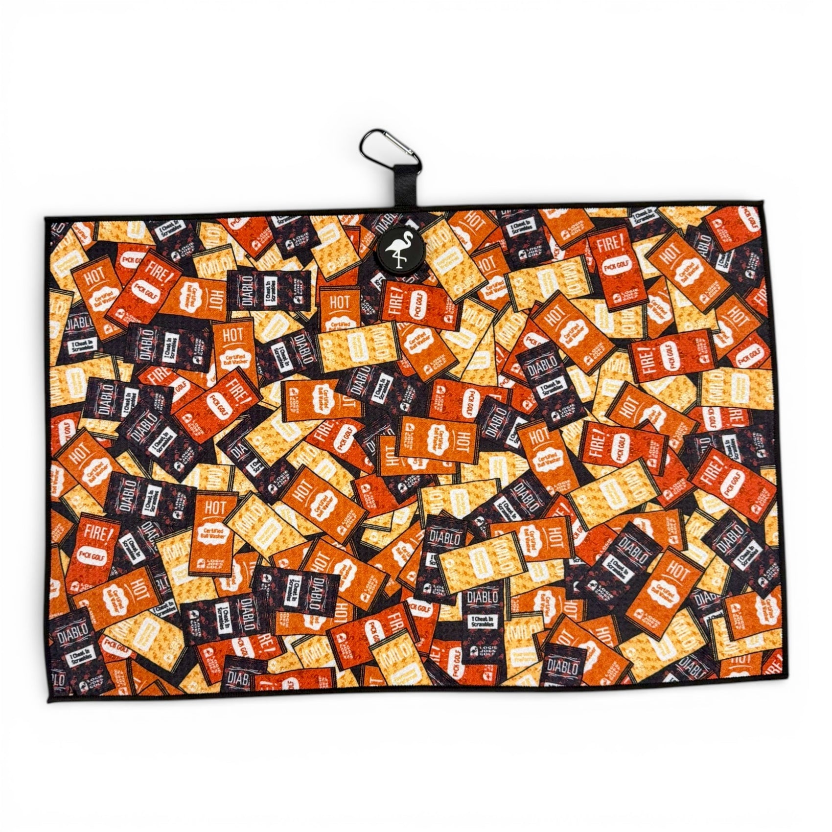 The Hot Sauce Golf Towel features premium double-sided microfiber in a 24 x 16 in size with a colorful Taco Bell sauce packet pattern, heavy-duty magnetic backing, black border, and carabiner clip—perfect for the golf course.