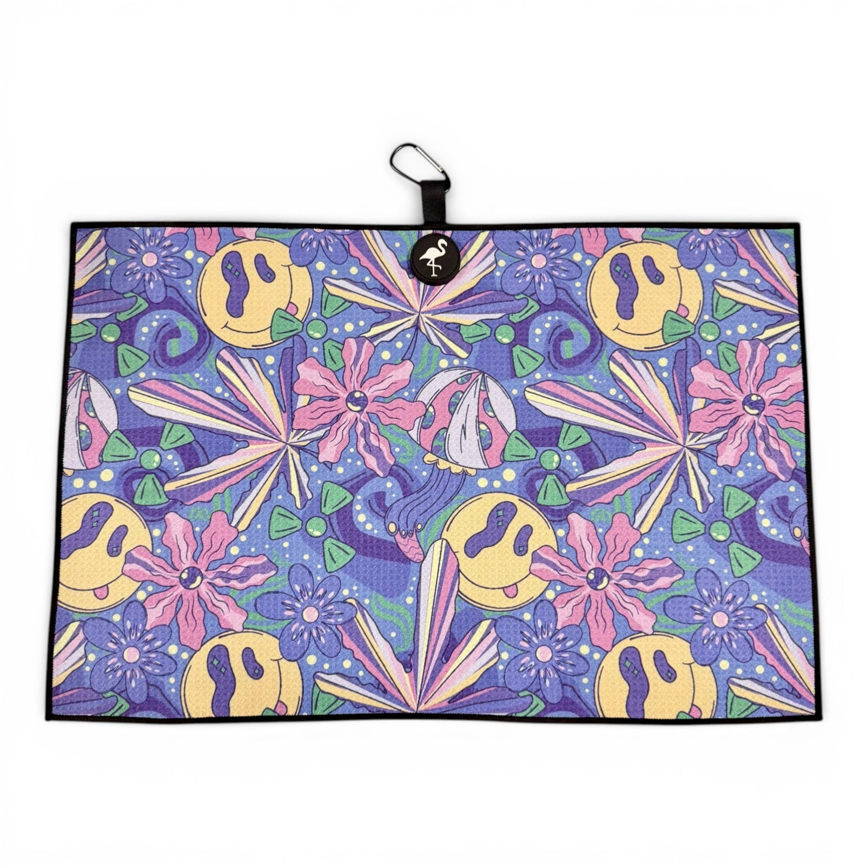 The Purple Haze Golf Towel is a premium double-sided microfiber towel (24x16 in) with a 90s-inspired psychedelic pattern, yellow smiley faces, pink and purple flowers, green triangles, black border, logo loop, magnet & carabiner clip.