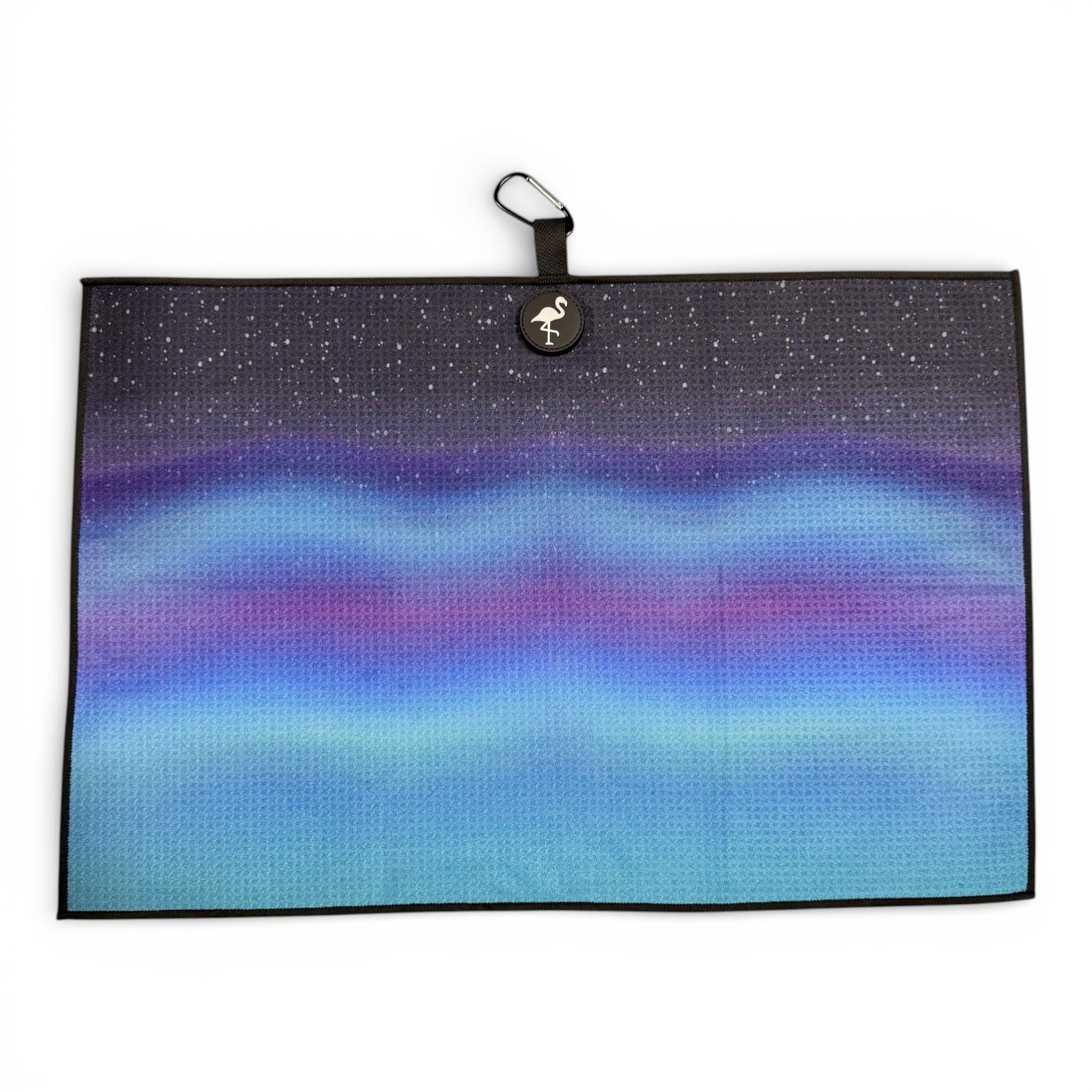 The Northern Lights Golf Towel is a 24x16 in double-sided microfiber towel featuring aurora-inspired blue, purple, and pink gradients, a circular flamingo logo, black loop with carabiner clip, and heavy-duty magnetic attachment.
