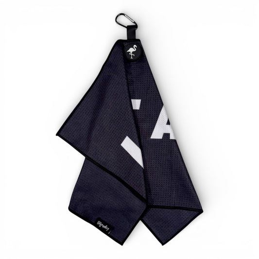 A Novelty Black Golf Towel, 24x16 in, made of premium double-sided microfiber with a heavy-duty magnetic carabiner clip, features a white flamingo logo tag and bold white lettering—photographed on a white background.