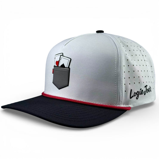 The Pocket Aces Golf Hat is a gray and black snapback cap with an adjustable fit, built-in magnetic ball marker holder (marker included), featuring a pocket aces graphic on the front and ventilation holes for comfort.