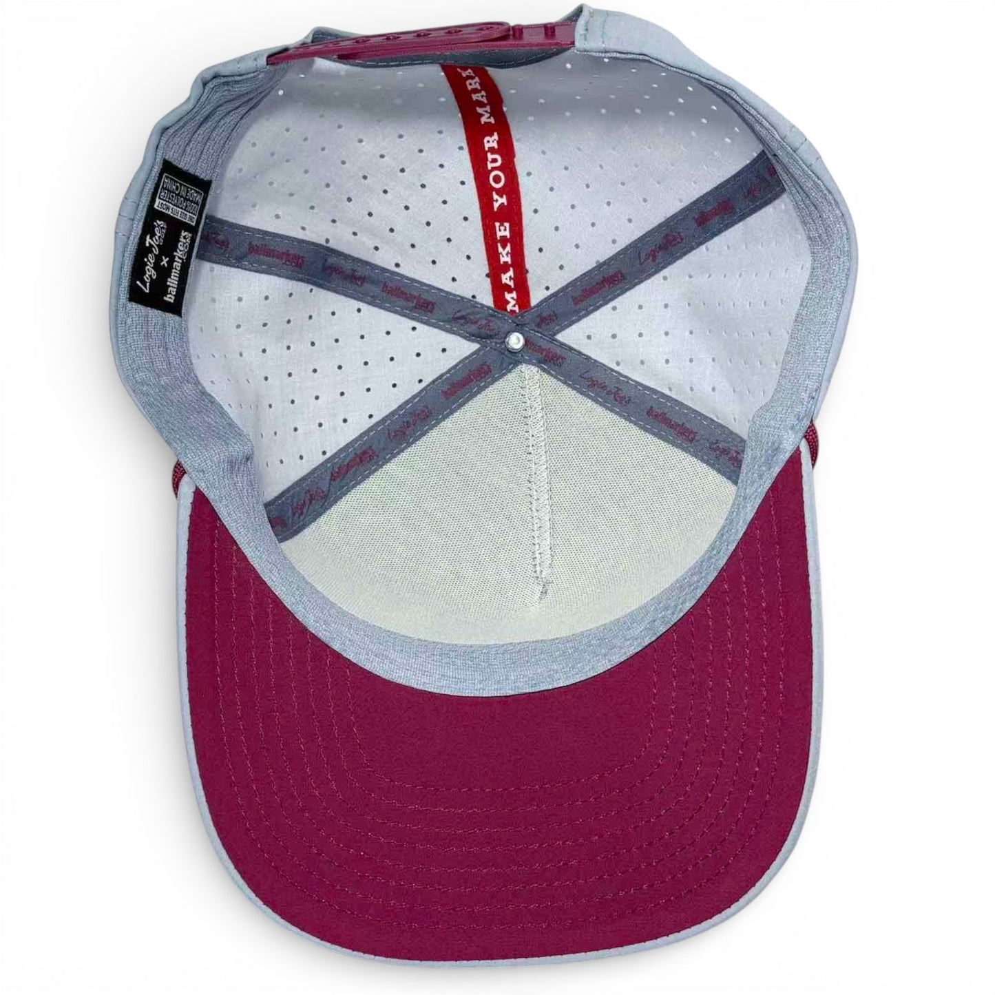 Inside view of the Transfusion Golf Hat Snapback Cap in light gray, showing perforated white lining, interior seams, and a red strip with "MAKE YOUR MARK"—plus a built-in magnetic ball marker holder with marker included.