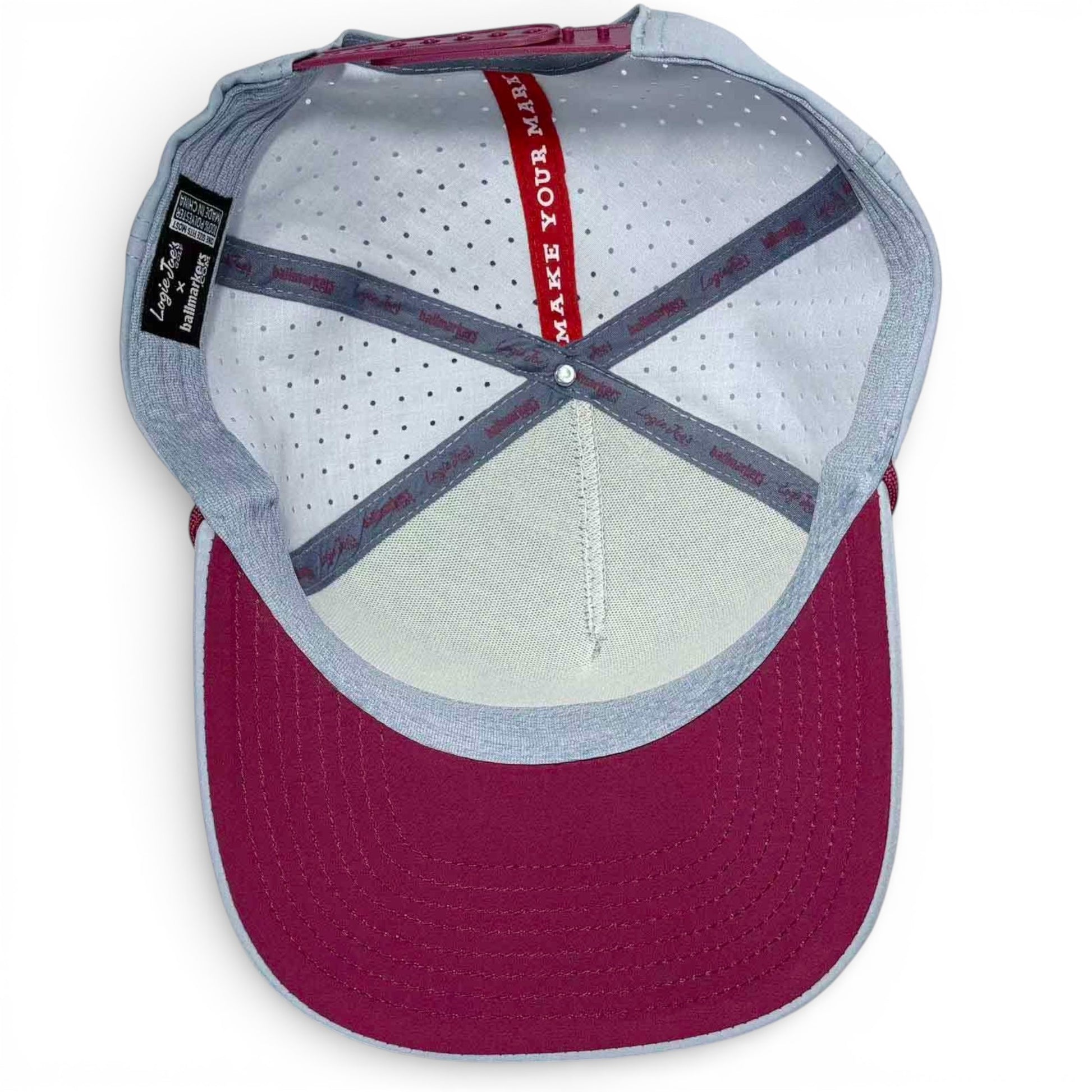 Inside view of the Transfusion Golf Hat Snapback Cap in light gray, showing perforated white lining, interior seams, and a red strip with "MAKE YOUR MARK"—plus a built-in magnetic ball marker holder with marker included.
