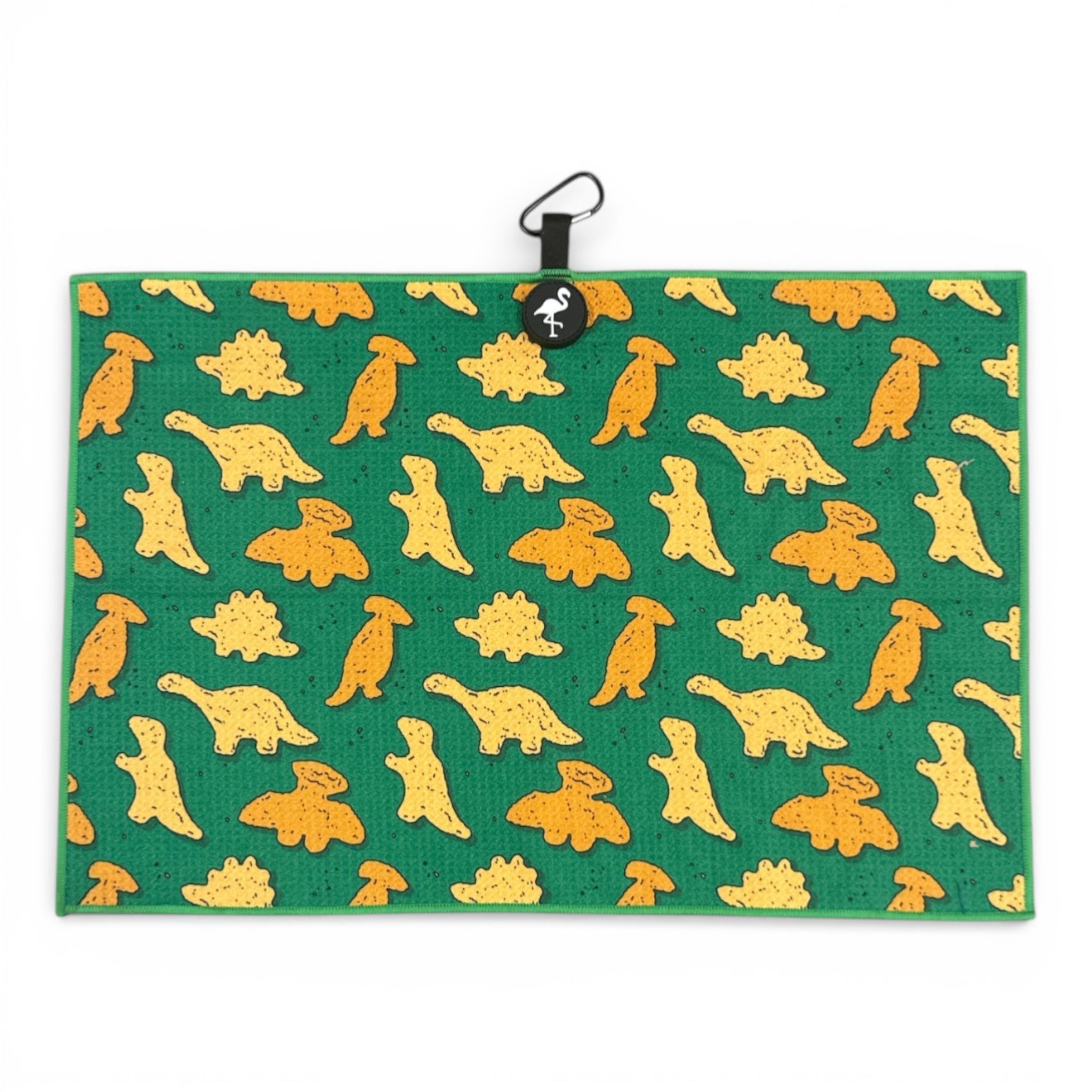 The Green Dino Nugget Golf Towel is a 24 x 16 in premium double-sided microfiber towel with yellow and orange dino shapes, a black hanging loop, magnetic back, and carabiner clip for easy attachment.
